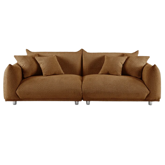 Modern rust brown upholstered sofa with deep seating and chrome-finished legs, featuring 4 matching accent pillows for a warm, stylish living room.
