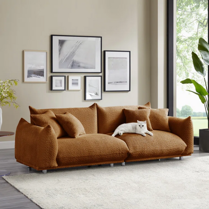Modern rust brown upholstered sofa with deep seating and chrome-finished legs, featuring 4 matching accent pillows for a warm, stylish living room.