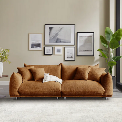 Modern rust brown upholstered sofa with deep seating and chrome-finished legs, featuring 4 matching accent pillows for a warm, stylish living room.