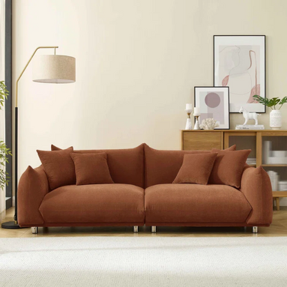 Modern rust upholstered sofa with deep seating and chrome-finished legs, featuring 4 matching accent pillows, perfect for contemporary living rooms.