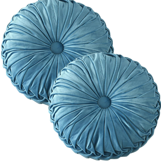 Muted blue velvet round throw pillows with pleated detailing and button center, 14.5-inch set of two styled on a neutral-toned sofa.


