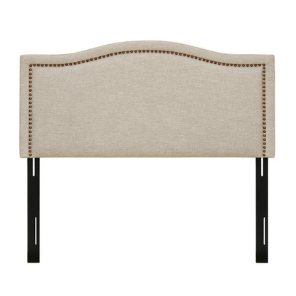 Natural beige upholstered king headboard with curved silhouette, silver nailhead trim, and adjustable metal legs for bed frame mounting

