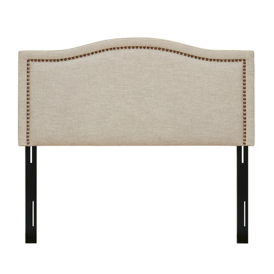 Natural beige upholstered king headboard with curved silhouette, silver nailhead trim, and adjustable metal legs for bed frame mounting

