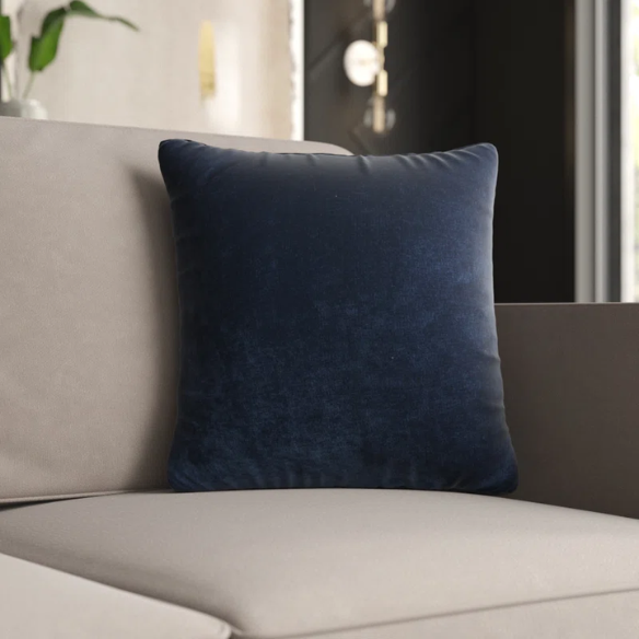 Navy blue crushed velvet throw pillow, square 16x16 design with soft texture and reversible cover, styled on a modern sofa for cozy, elegant home decor.

