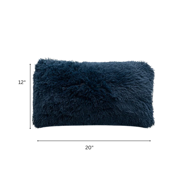 Set of two navy blue faux fur throw pillows with shaggy texture on a neutral-toned modern sofa

