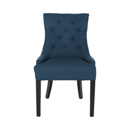 Set of four navy blue upholstered dining chairs featuring diamond tufted backs, armless design, sloped sides, and espresso brown wooden legs.

