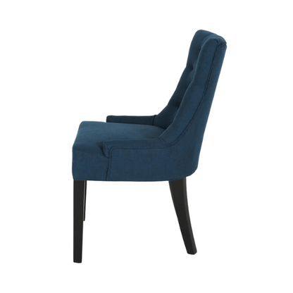 Set of four navy blue upholstered dining chairs featuring diamond tufted backs, armless design, sloped sides, and espresso brown wooden legs.

