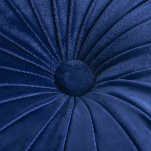 Navy blue velvet round throw pillows with hand-sewn pleats and button center, 14.5-inch set of two styled on a neutral-toned sofa.

