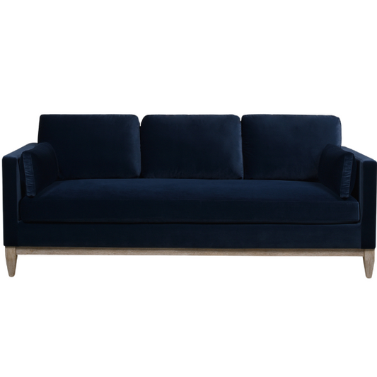 Navy blue velvet 3-seater sofa with feather-down cushions, track arms, and solid wood legs, designed for modern and transitional interiors.

