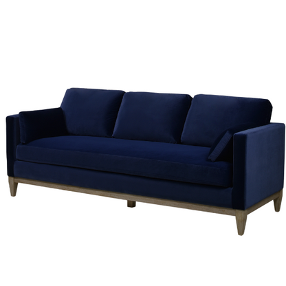 Navy blue velvet 3-seater sofa with feather-down cushions, track arms, and solid wood legs, designed for modern and transitional interiors.

