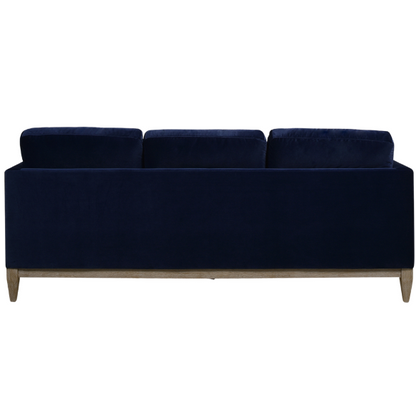 Navy blue velvet 3-seater sofa with feather-down cushions, track arms, and solid wood legs, designed for modern and transitional interiors.

