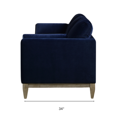 Navy blue velvet 3-seater sofa with feather-down cushions, track arms, and solid wood legs, designed for modern and transitional interiors.


