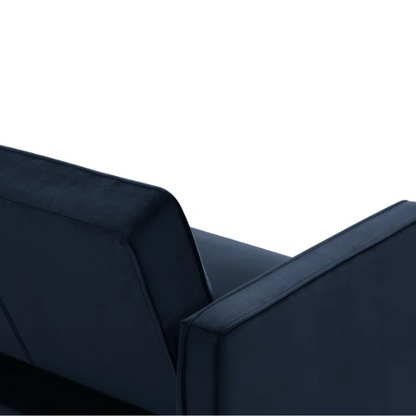 Navy blue velvet convertible sofa with vertical tufting, square arms, and brown tapered legs, designed with a split-back reclining feature and twin bed conversion.
