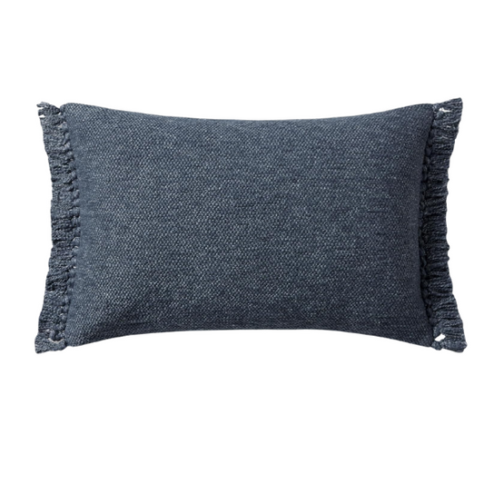 Navy lumbar throw pillow with fringe, rectangular 13x21 design, cotton blend fabric, styled on a modern sofa for cozy interior decor.

