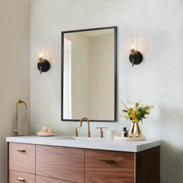 Nordic modern wall sconce with matte black finish, electroplated brass arm, and clear cylindrical glass shade – stylish uplight or downlight fixture

