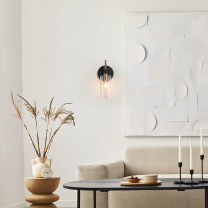 Nordic modern wall sconce with matte black finish, electroplated brass arm, and clear cylindrical glass shade – stylish uplight or downlight fixture

