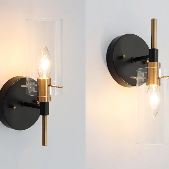 Nordic modern wall sconce with matte black finish, electroplated brass arm, and clear cylindrical glass shade – stylish uplight or downlight fixture

