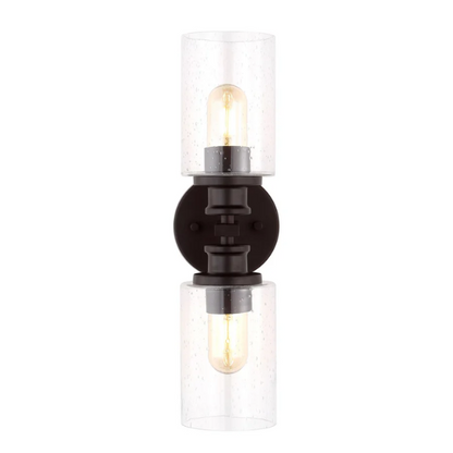 Oil-rubbed bronze wall sconce with dual clear seeded glass cylinder shades and Edison-style LED bulbs, perfect for rustic, farmhouse, or traditional interiors

