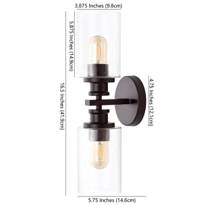 Oil-rubbed bronze wall sconce with dual clear seeded glass cylinder shades and Edison-style LED bulbs, perfect for rustic, farmhouse, or traditional interiors

