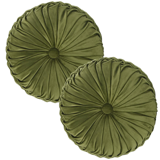 Olive green velvet round throw pillows with hand-pleated detailing and button center, styled on a beige sofa for a warm, inviting look.

