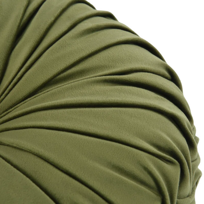 Olive green velvet round throw pillows with hand-pleated detailing and button center, styled on a beige sofa for a warm, inviting look.

