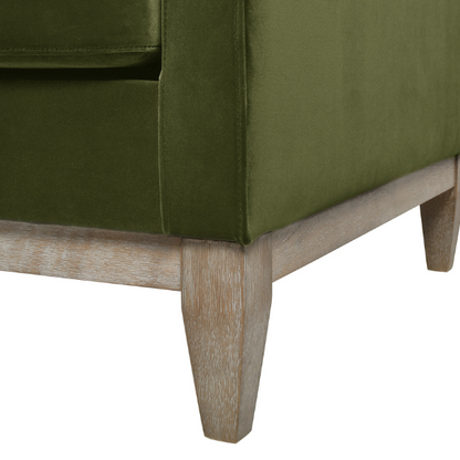 Olive green velvet 3-seater sofa with track arms, feather-down cushions, and natural wood base, ideal for modern and transitional living rooms.

