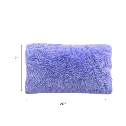 Set of two periwinkle faux fur throw pillows with fluffy texture on a light grey modern couch

