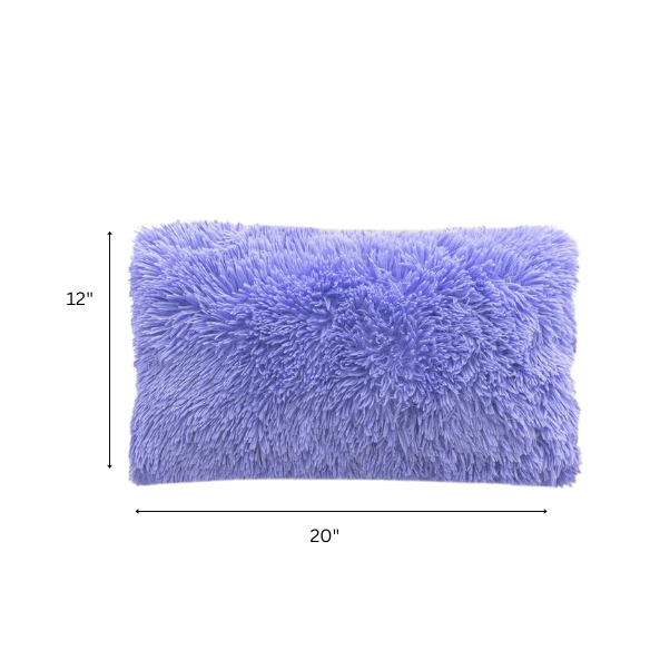 Set of two periwinkle faux fur throw pillows with fluffy texture on a light grey modern couch

