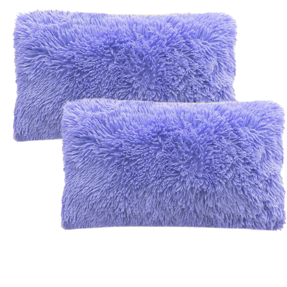 Set of two periwinkle faux fur throw pillows with fluffy texture on a light grey modern couch

