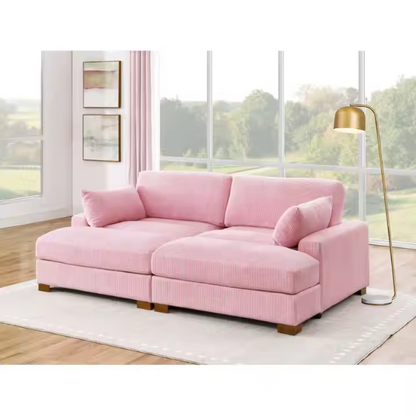 Pink corduroy convertible sleeper sofa with adjustable headrest, twin bed functionality, and mid-century wood legs
