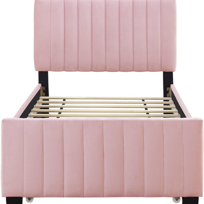 Pink twin upholstered platform bed with tufted velvet headboard and pull-out trundle, designed for kids, teens, or guest rooms, featuring a soft pink finish and space-saving design.

