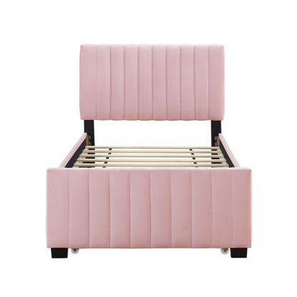Pink twin upholstered platform bed with tufted velvet headboard and pull-out trundle, designed for kids, teens, or guest rooms, featuring a soft pink finish and space-saving design.


