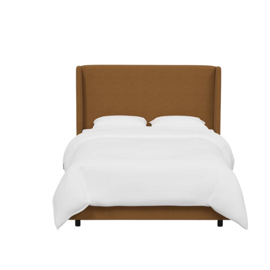 Amber king-size upholstered bed in linen fabric with wingback headboard and low-profile black metal legs.

