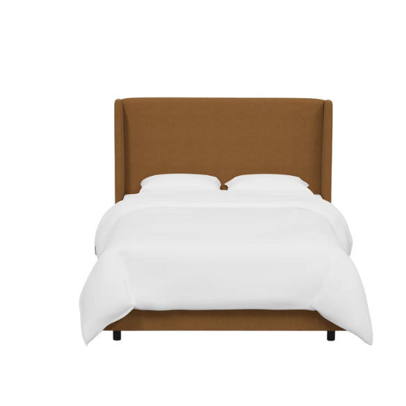 Amber king-size upholstered bed in linen fabric with wingback headboard and low-profile black metal legs.

