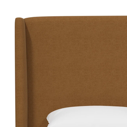Amber king-size upholstered bed in linen fabric with wingback headboard and low-profile black metal legs.

