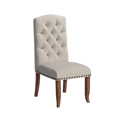 Set of 2 beige button-tufted farmhouse dining chairs with rustic wood legs, nailhead trim, and upholstered linen-like fabric.

