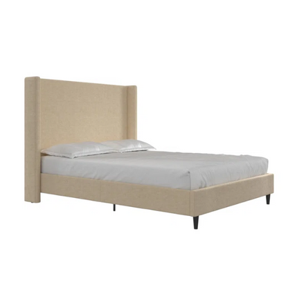 Beige canvas queen bed with tall wingback headboard and black conical legs, styled in a modern bedroom setting.

