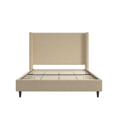 Beige canvas queen bed with tall wingback headboard and black conical legs, styled in a modern bedroom setting.

