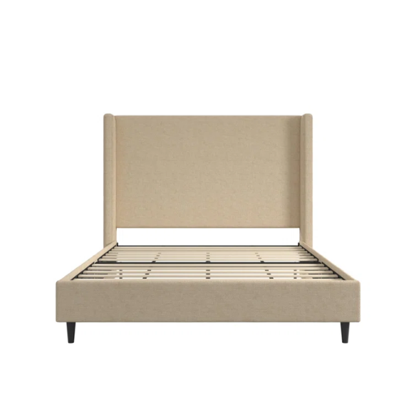 Beige canvas queen bed with tall wingback headboard and black conical legs, styled in a modern bedroom setting.

