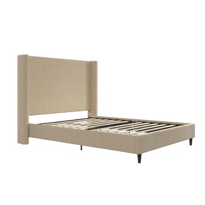 Beige canvas queen bed with tall wingback headboard and black conical legs, styled in a modern bedroom setting.

