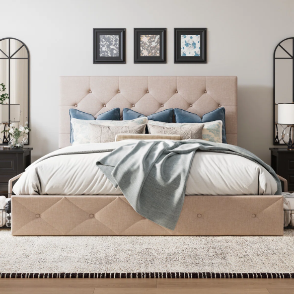 Beige upholstered queen bed with diamond-tufted headboard and four underbed storage drawers on wheels.

