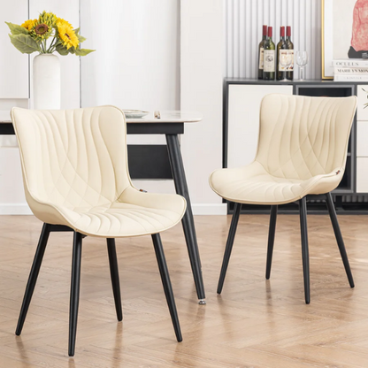 Set of 2 beige faux leather dining chairs with modern fishtail backrest and black metal legs, designed for contemporary dining spaces.

