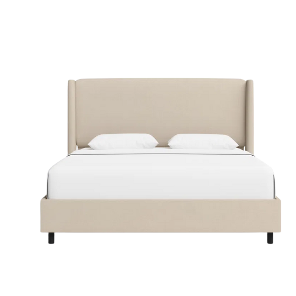 Beige king-size upholstered bed in linen fabric with wingback headboard and low-profile black metal legs.


