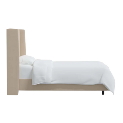 Beige king-size upholstered bed in linen fabric with wingback headboard and low-profile black metal legs.

