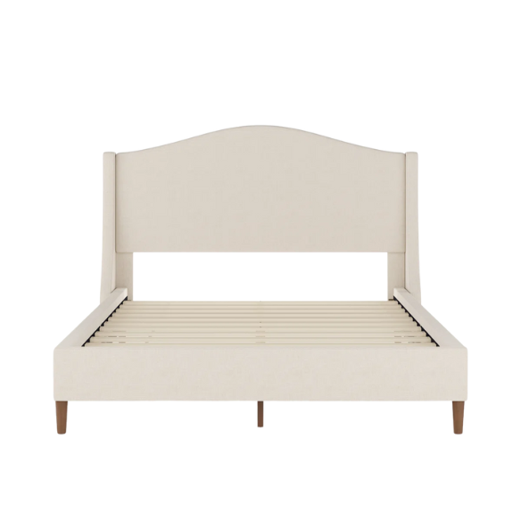 Full-size beige upholstered platform bed with curved wingback headboard, cushioned side rails, and tapered wooden legs, shown in a modern bedroom setting.

