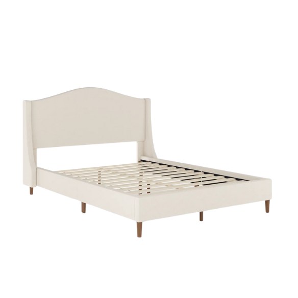 Full-size beige upholstered platform bed with curved wingback headboard, cushioned side rails, and tapered wooden legs, shown in a modern bedroom setting.

