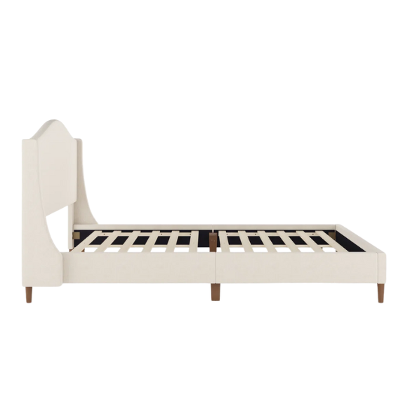 Full-size beige upholstered platform bed with curved wingback headboard, cushioned side rails, and tapered wooden legs, shown in a modern bedroom setting.

