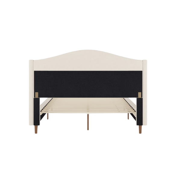 Full-size beige upholstered platform bed with curved wingback headboard, cushioned side rails, and tapered wooden legs, shown in a modern bedroom setting.

