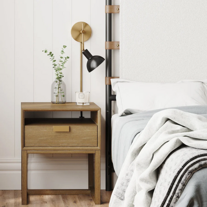 Black and brass plug-in wall sconce with adjustable swing arm and bell-shaped brass shade, featuring built-in switch and cord cover for bedside or reading nook lighting

