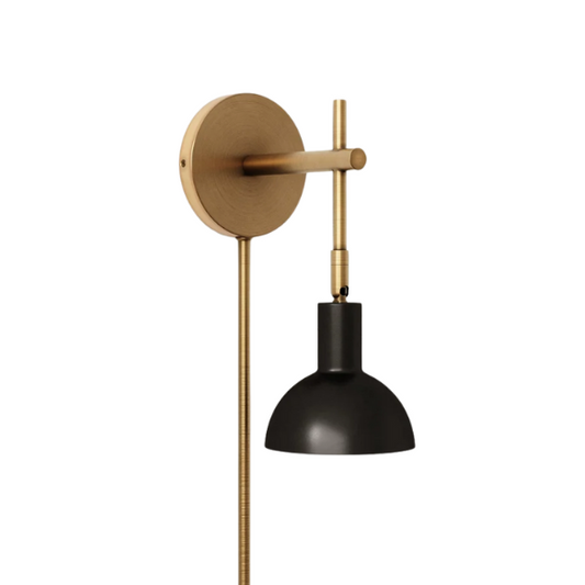 Black and brass plug-in wall sconce with adjustable swing arm and bell-shaped brass shade, featuring built-in switch and cord cover for bedside or reading nook lighting

